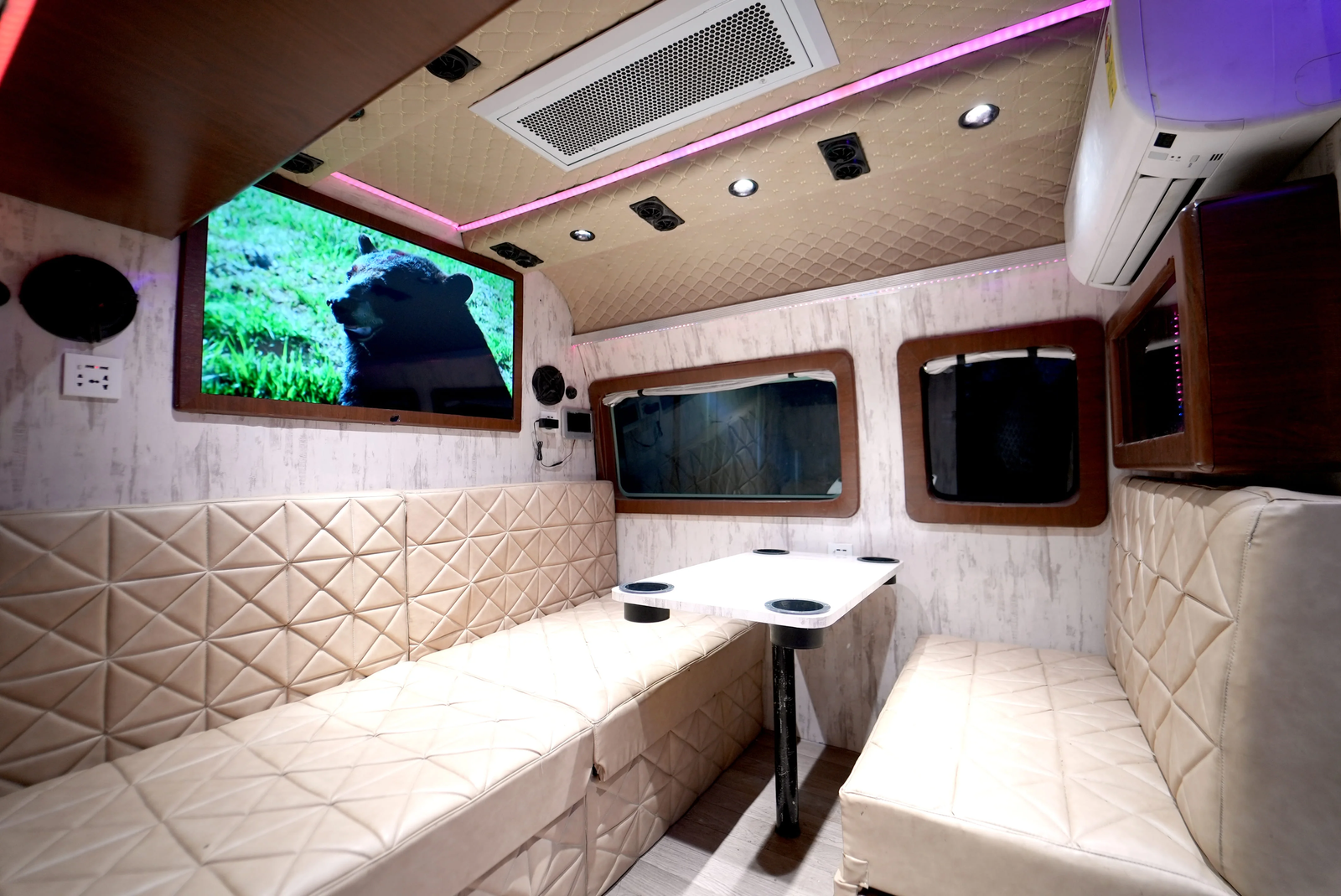 Carvan Motorhome Sofa Cum bed with dining table with hot and cold AC